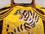 a yellow and brown bag with a tiger on it