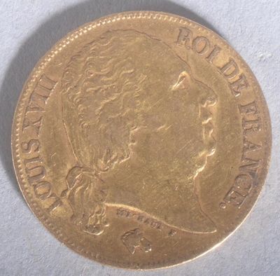 a close up of a gold coin on a white surface
