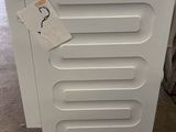 a stack of white appliances on display in a store