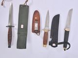 several different types of knives are displayed on a white surface