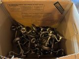a cardboard box filled with a bunch of different types of hooks