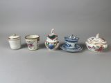 several different types of tea cups and saucers are lined up on a table