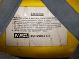 a close up of a yellow gas can with a label on it