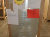 a refrigerator that is wrapped in plastic and ready to be shipped
