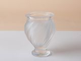a clear glass vase sitting on a white table
