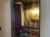 a table and chairs in a room with a mirror on the wall