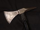 an old metal axe with a black handle on a black background