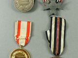three medals and a medal on a table with a gray background