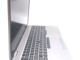 a laptop computer that is open on a white surface