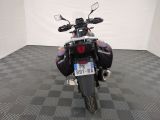 a motorcycle that is parked in a room with a checkered floor