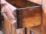 a wooden cabinet with a drawer in it