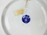 a plate with a tea bag on it and a tea bag on the plate