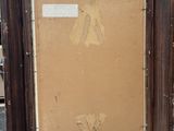 an old picture frame sitting on top of a wooden floor next to a pile of boxes
