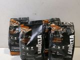 three bags of coffee sitting on top of a white table