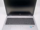 an open laptop computer sitting on top of a white table