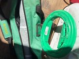 a green bag and a pair of scissors on a table