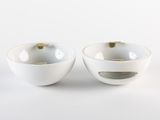 two bowls that are sitting side by side on a white surface