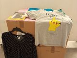 a pile of boxes with clothes on top of it