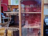 a wooden cabinet with a glass door in a room