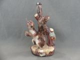 a figurine of a squirrel and a squirrel on a tree stump