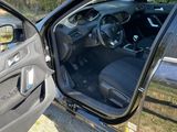 a black car with its door open next to a black car