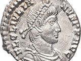 a silver coin with an image of a woman wearing a headdress