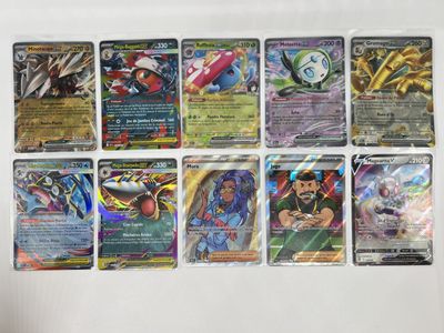 a lot of different pokemon cards on the table
