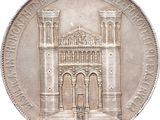 an old silver coin with a picture of a building on it