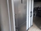 a silver refrigerator in the middle of a kitchen