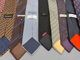 many ties that are lined up together on a table
