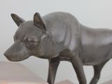 a statue of a dog that is standing on a table