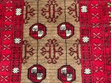 an oriental rug with red and brown designs on a red ground