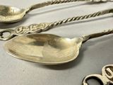 three spoons that are sitting on a table