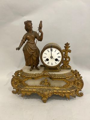a statue of a woman holding a bird next to a clock