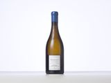 a bottle of white wine sitting on a table