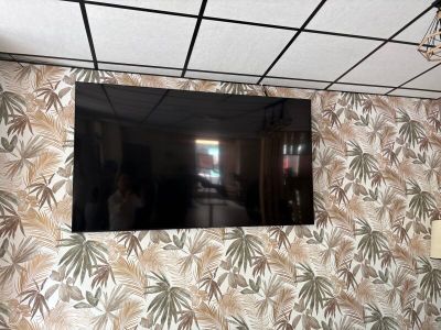 a flat screen tv mounted on a wall in a room