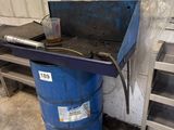 a blue barrel sitting next to a metal step ladder