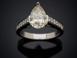 an engagement ring with a pear shaped diamond set in white gold