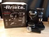 a black coffee maker sitting on a table next to a box of coffee