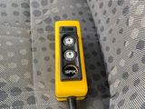 a yellow button on the back of a car seat
