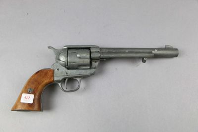 a close up of a revolver on a table with a tag on it