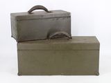 two suitcases sitting on top of each other on a white surface