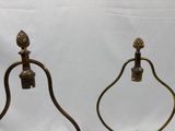 pair of antique brass candlesticks with pineapples on each end