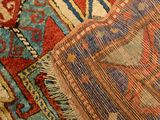 a close up of a rug with a red and blue design on it