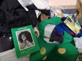 a pile of clothing and a book on the floor