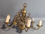 a gold chandelier with five candles on it