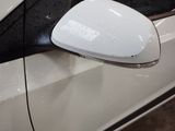 an image of a side view mirror on a white car