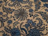 an image of a bed with a blue floral pattern on it