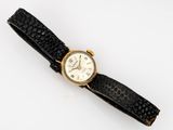 a close up of a wrist watch on a white surface