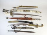 many different types of knives on display on a table